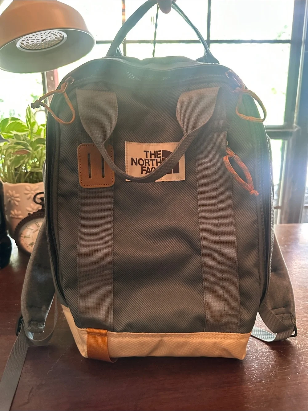 The North Face Light Blue Backpack with White Base and Yellow Accents
